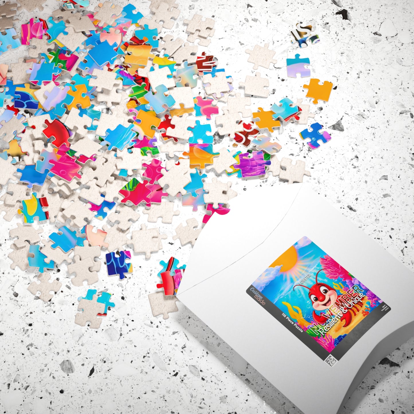 Colorful scattered puzzle pieces with kids birth month puzzle packaging on white surface