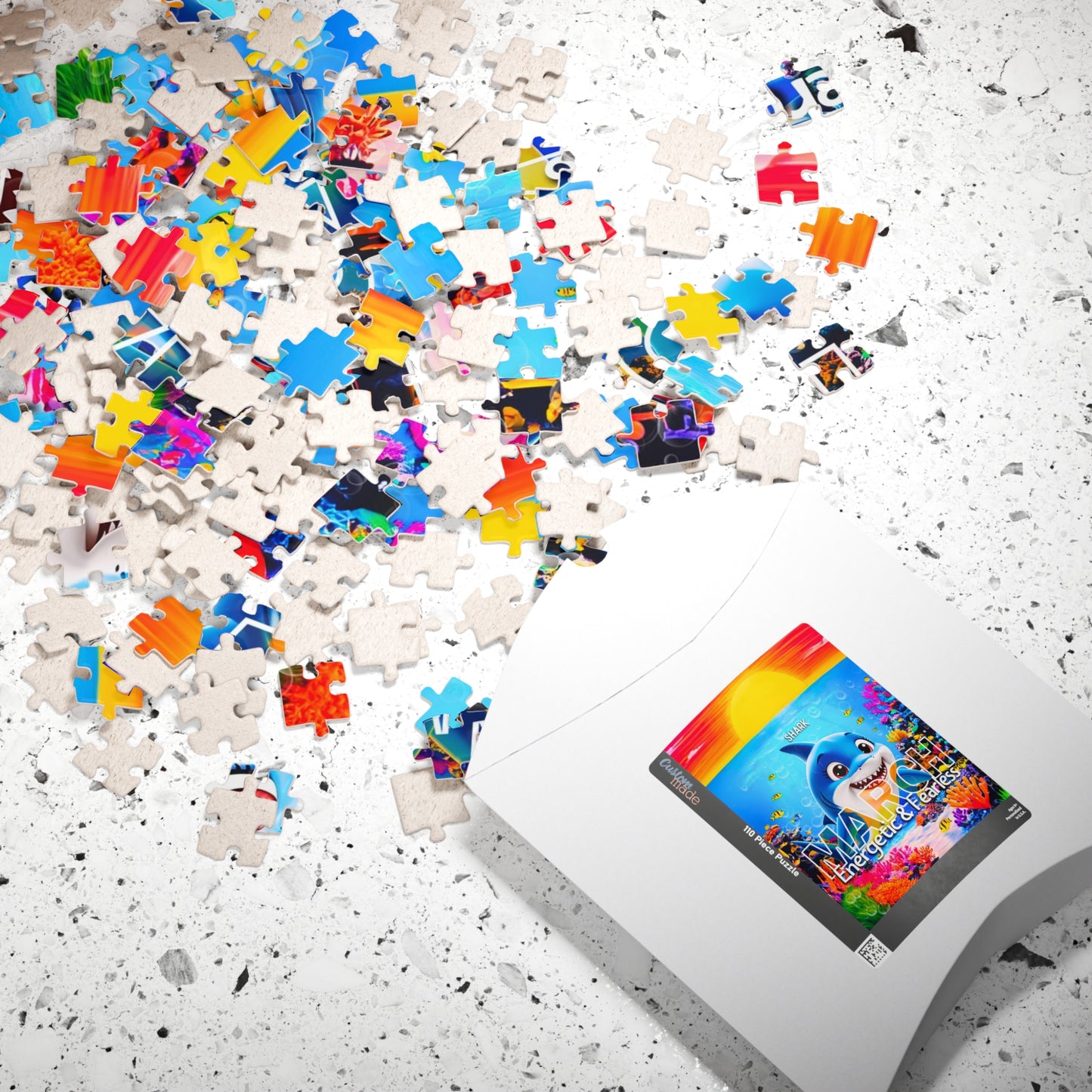 Kids birth month puzzle with colorful scattered pieces and white packaging on speckled surface