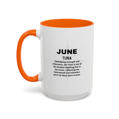 White birth month coffee mug with orange handle and interior, featuring text about June Tuna.