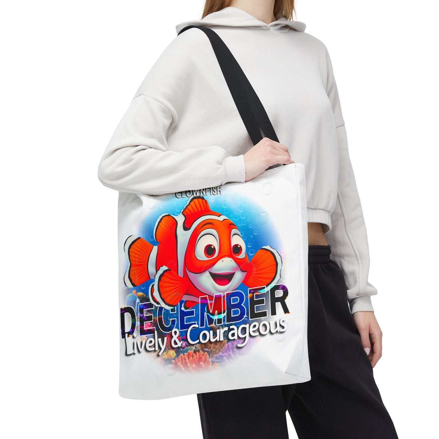 Kids birth month beach tote bag with colorful December clownfish design and black strap