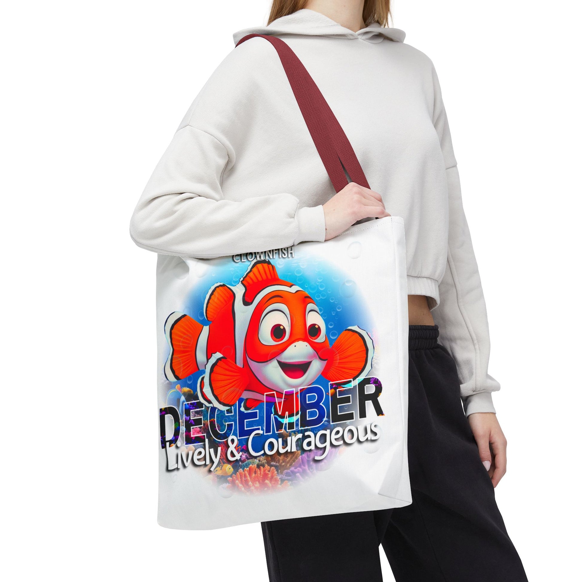 Kids birth month beach tote bag with colorful December clownfish design and red strap