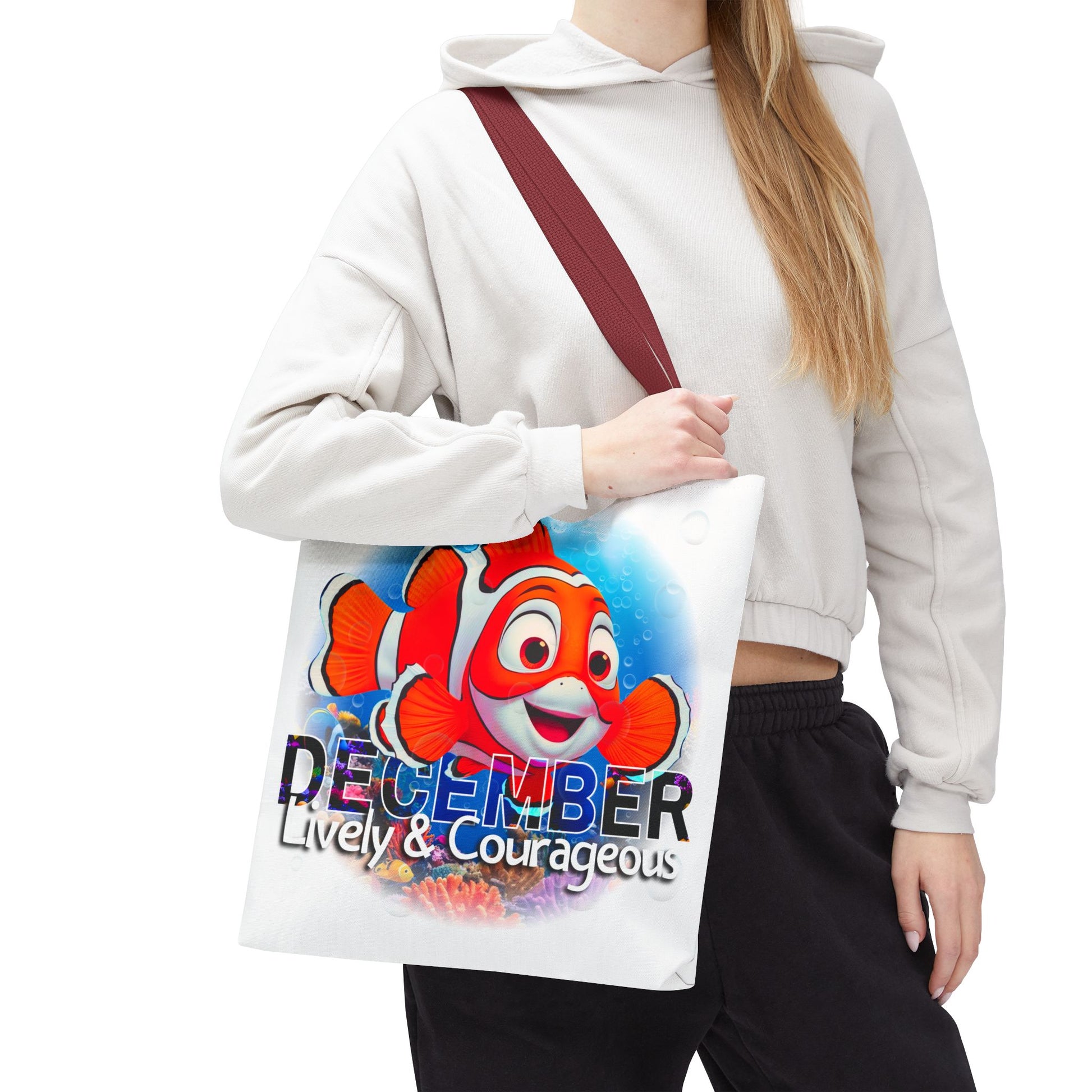 Kids birth month beach tote bag with colorful December clownfish design and lively courageous text