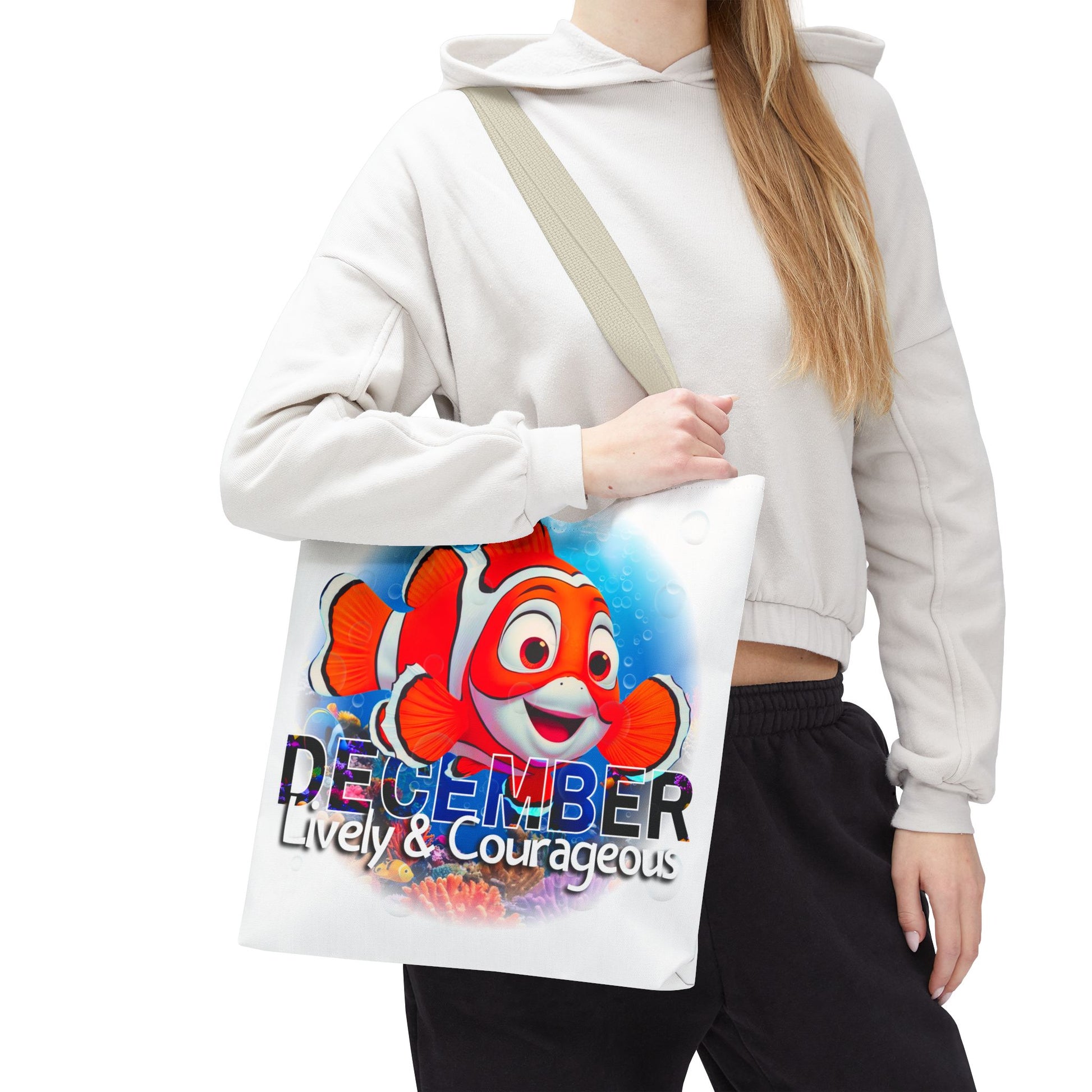 Kids birth month beach tote bag with colorful December clownfish design, and lively courageous text