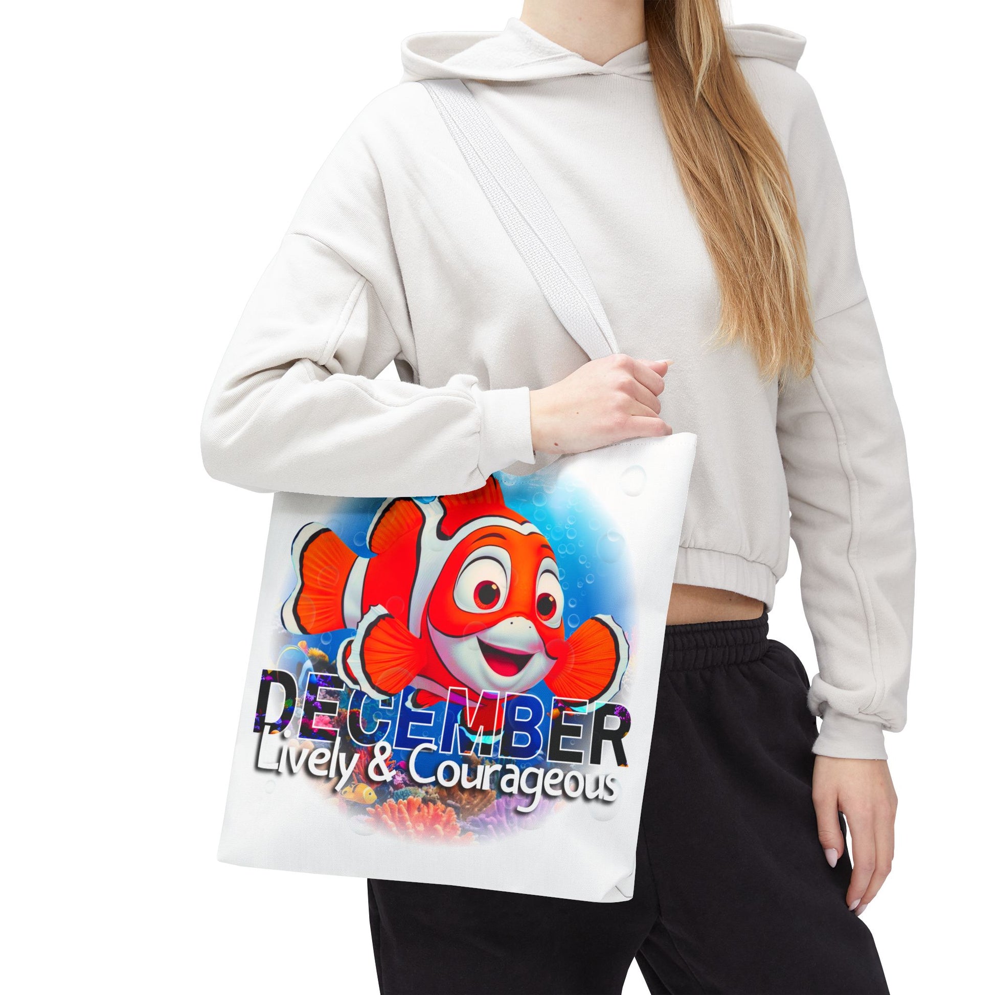 Kids birth month beach tote bag, with colorful December clownfish design and lively courageous text