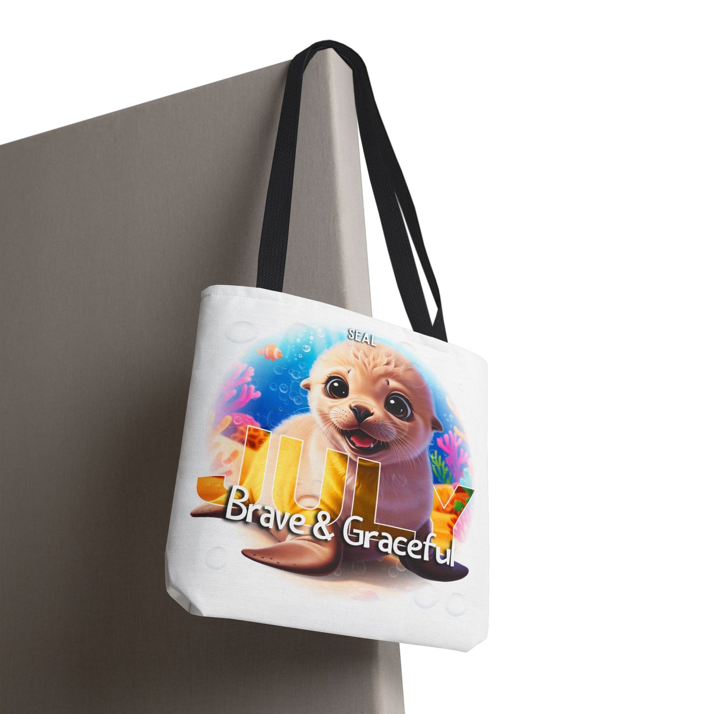 Kids birth month beach tote bag with seal design and July Brave and Graceful text