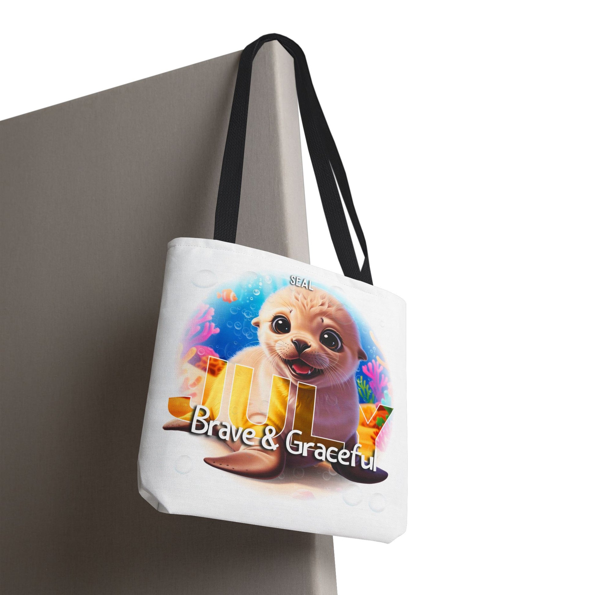 Kids birth month beach tote bag featuring a cute seal with July Brave and Graceful design