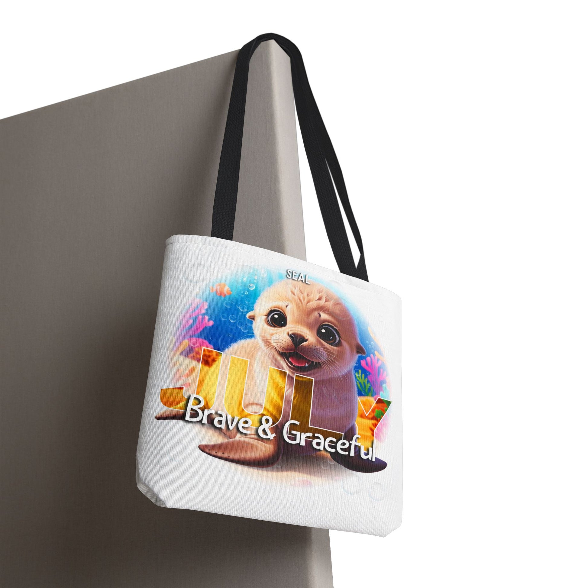 Kids birth month beach tote bag featuring a cute seal with Brave and Graceful text