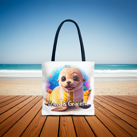 Kids birth month beach tote bag featuring a cute seal design with July and Brave and Graceful text