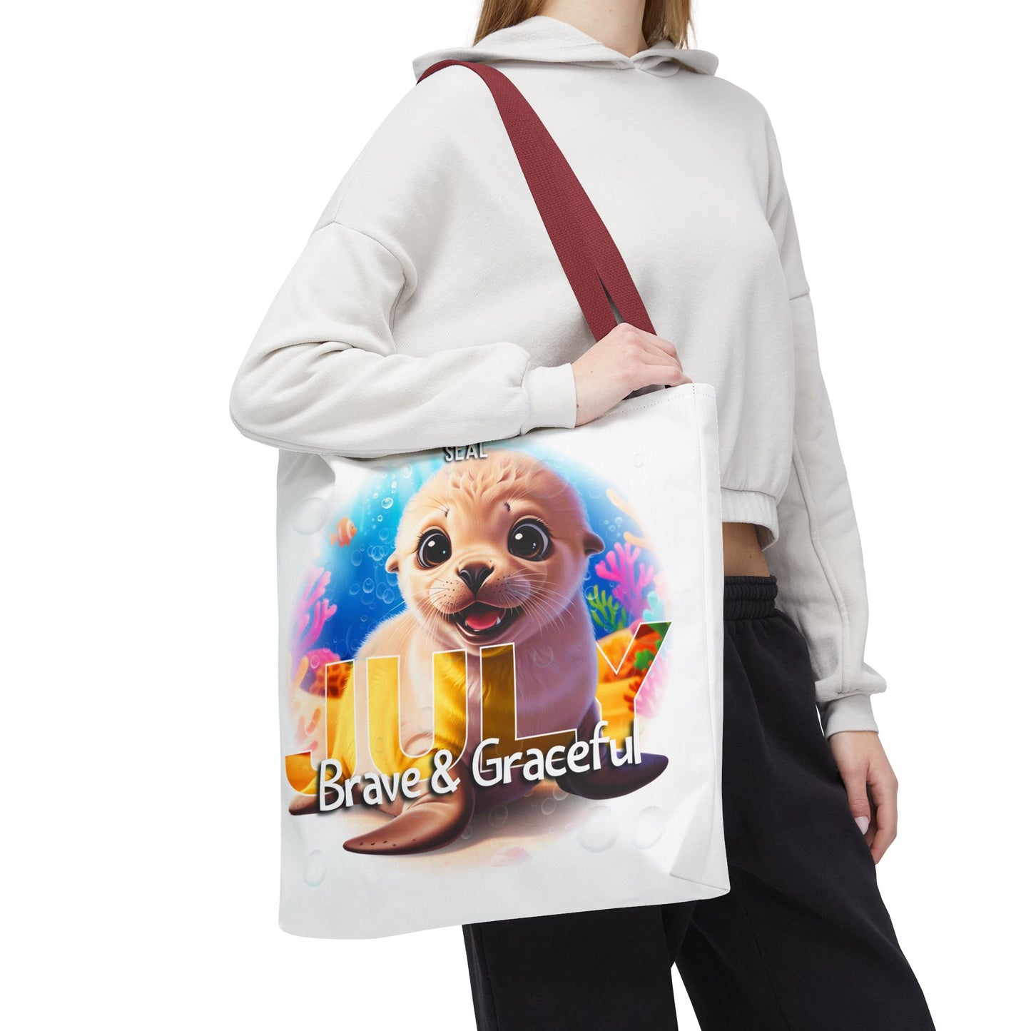 Kids birth month beach tote bag with cute seal and July design carried by woman