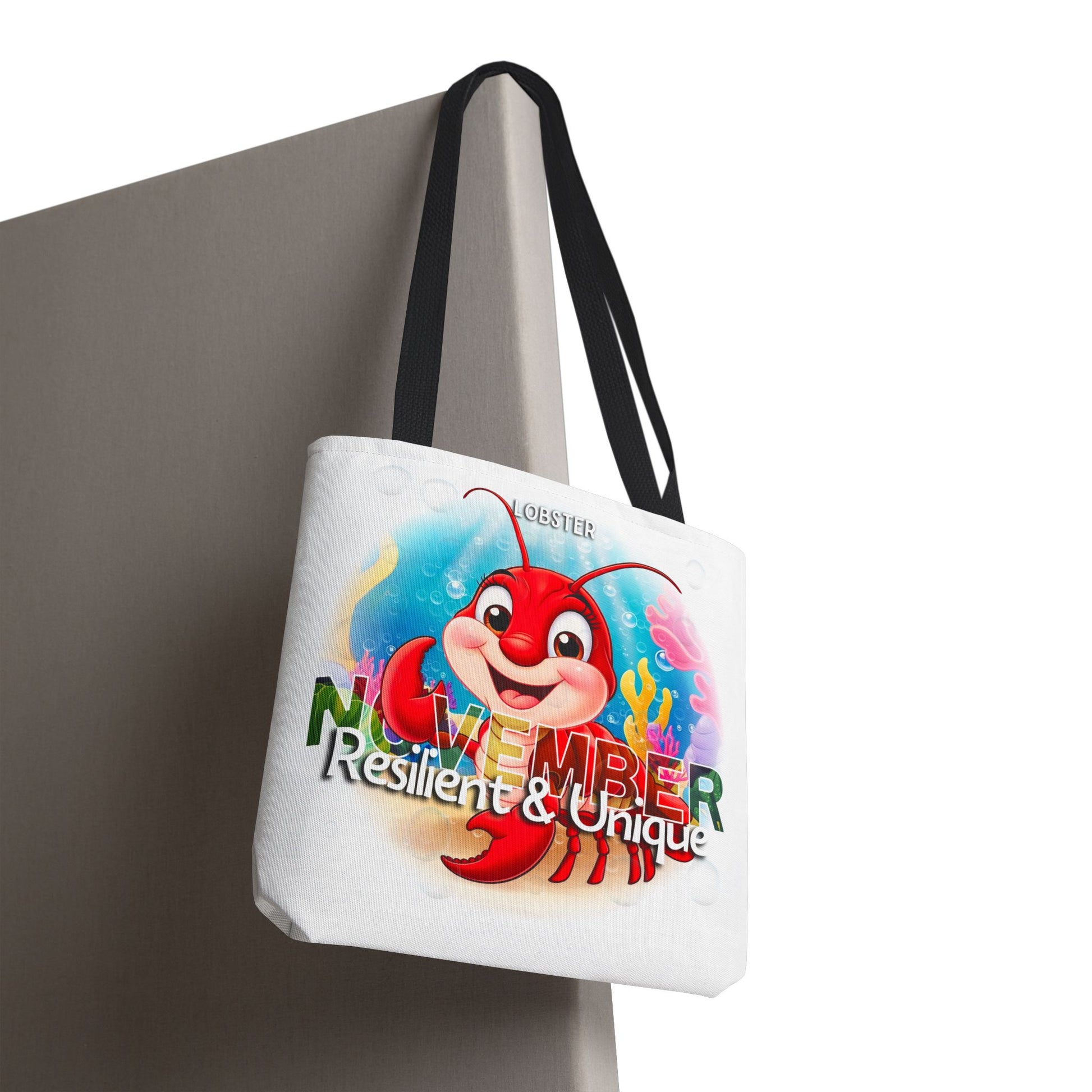 Kids birth month beach tote bag with colorful November lobster design and black straps