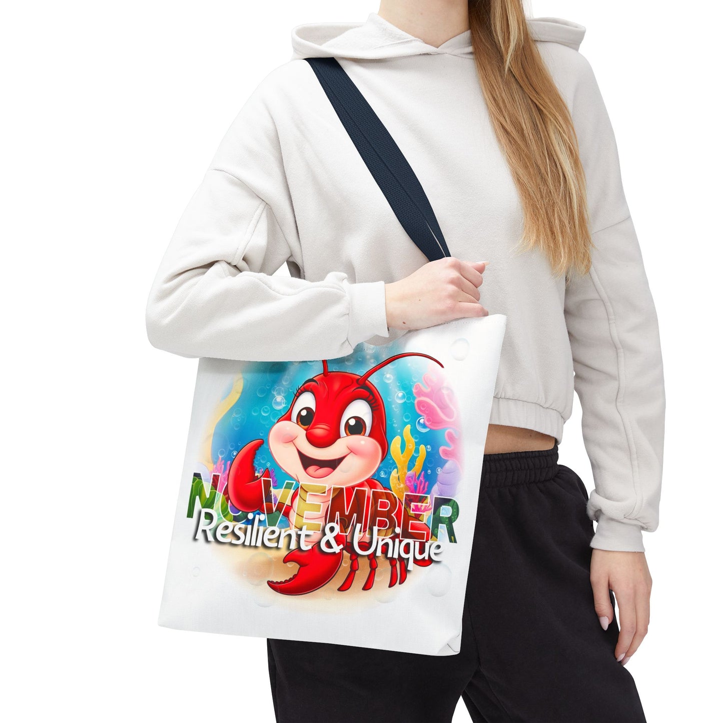 Kids birth month beach tote bag with colorful November lobster design and black strap