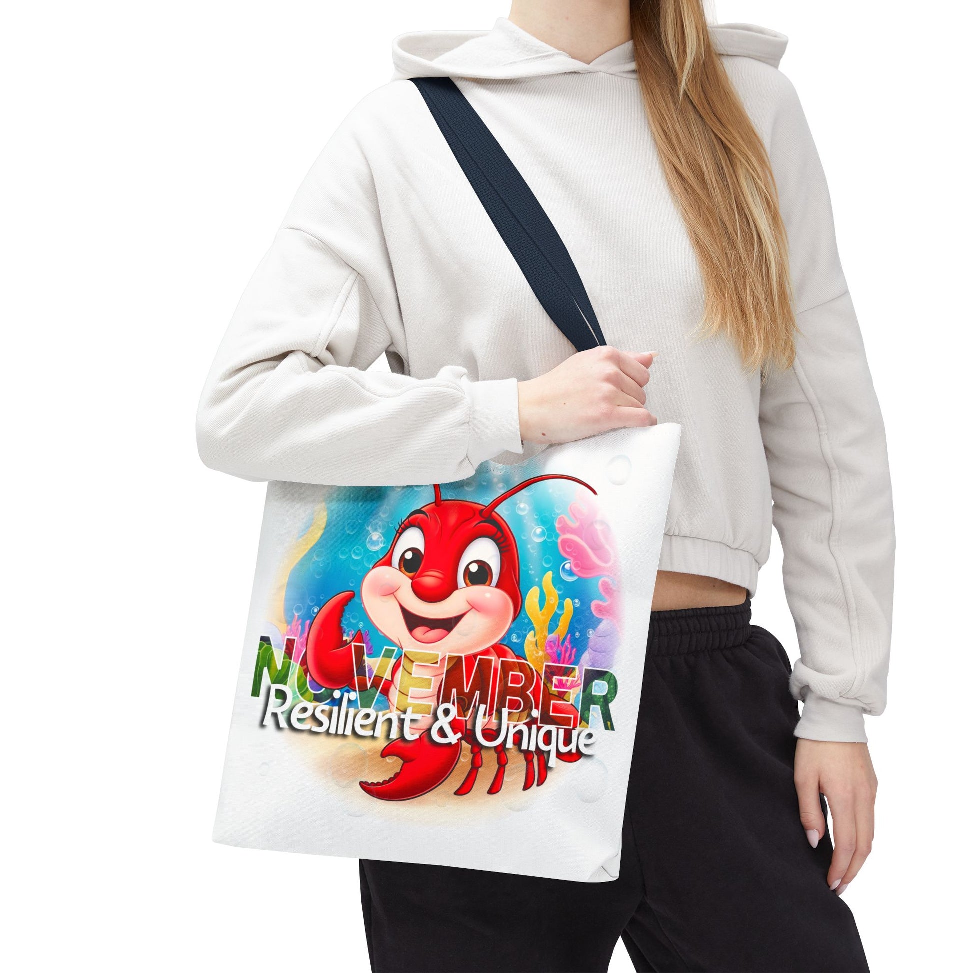 Kids birth month beach tote bag with colorful November lobster design and black strap