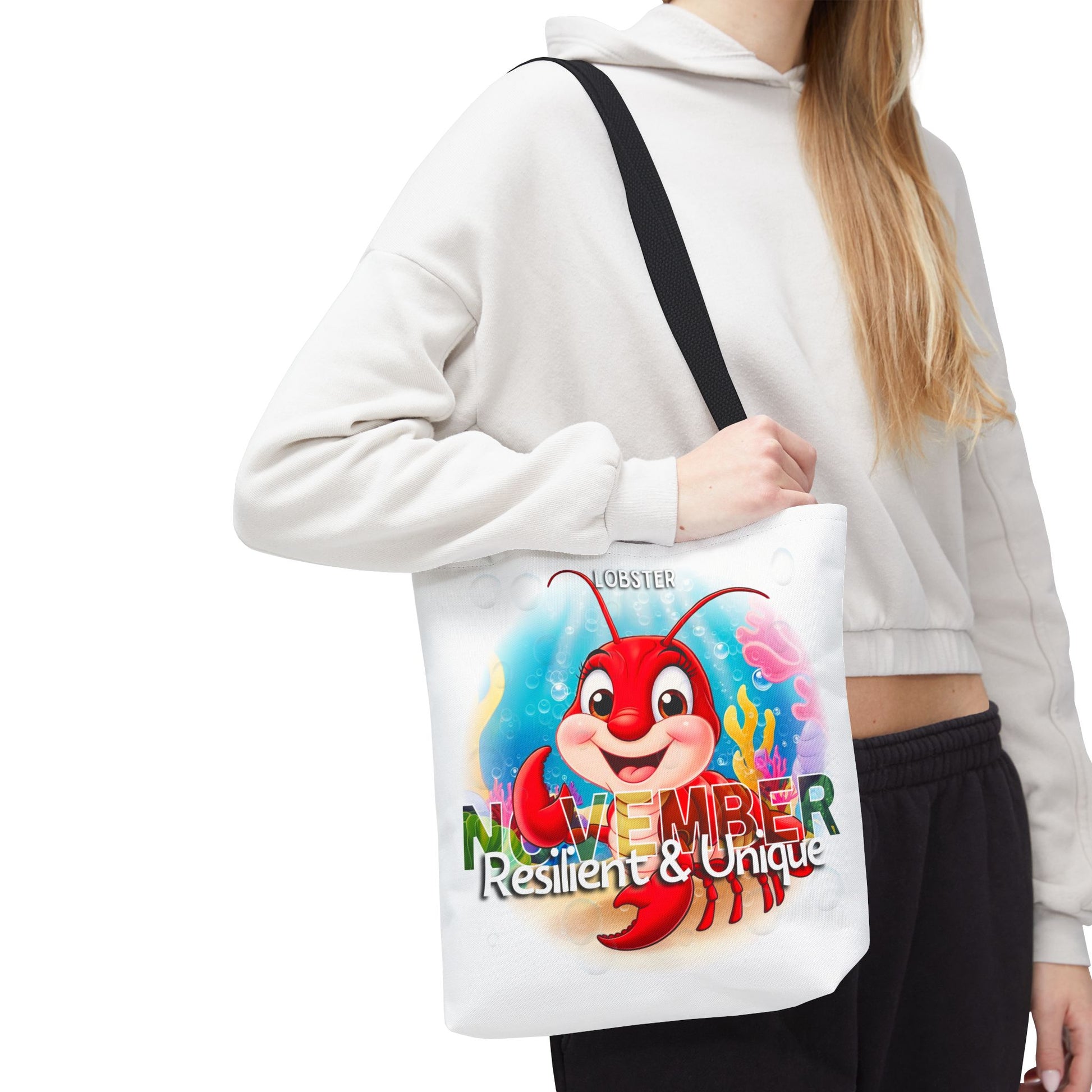 Kids birth month beach tote bag featuring a November lobster design with resilient and unique text