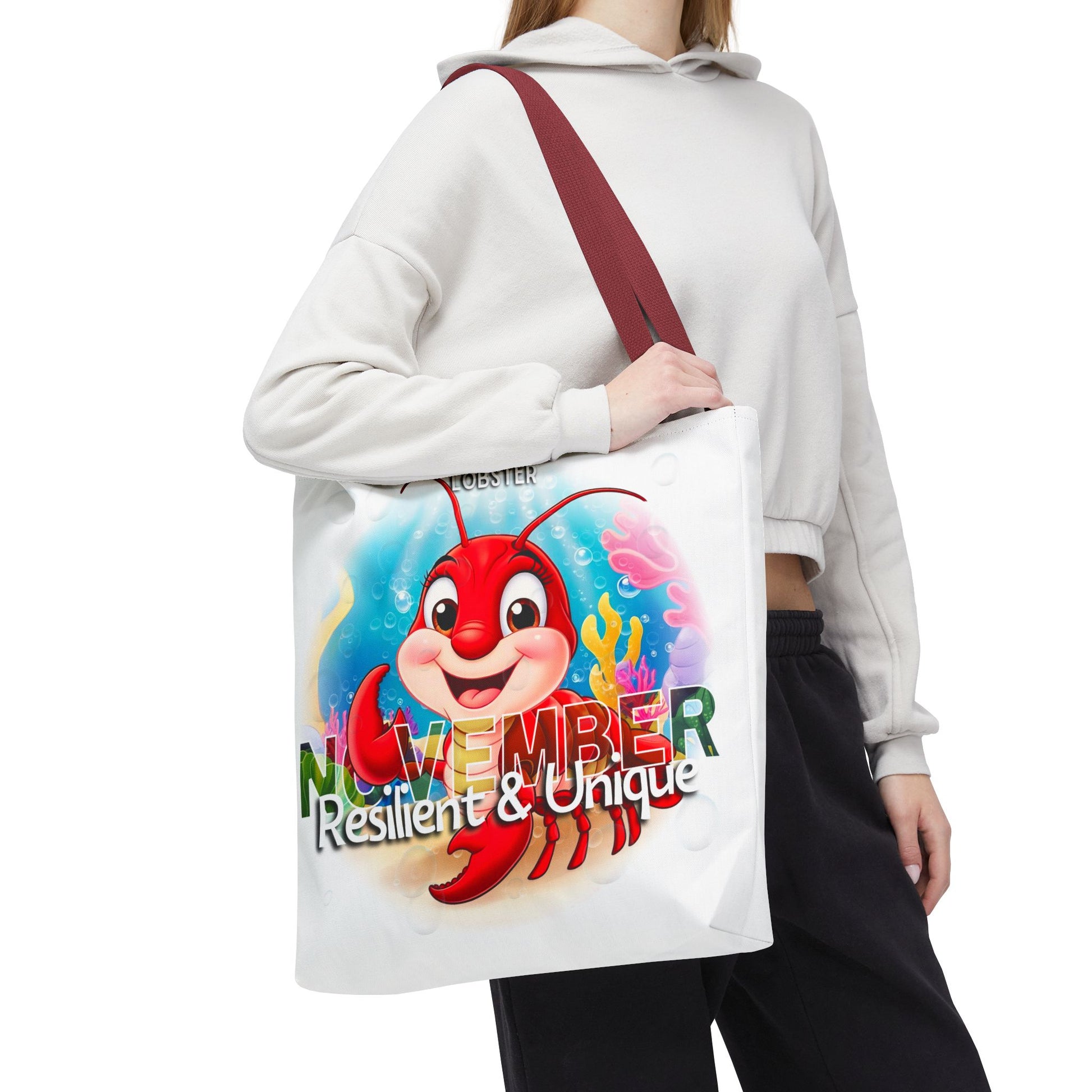 Kids birth month beach tote bag with colorful November lobster design and maroon strap