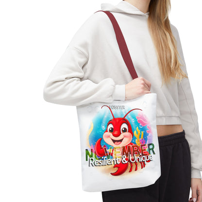 Kids birth month beach tote bag featuring a colorful November lobster design with resilient and unique text