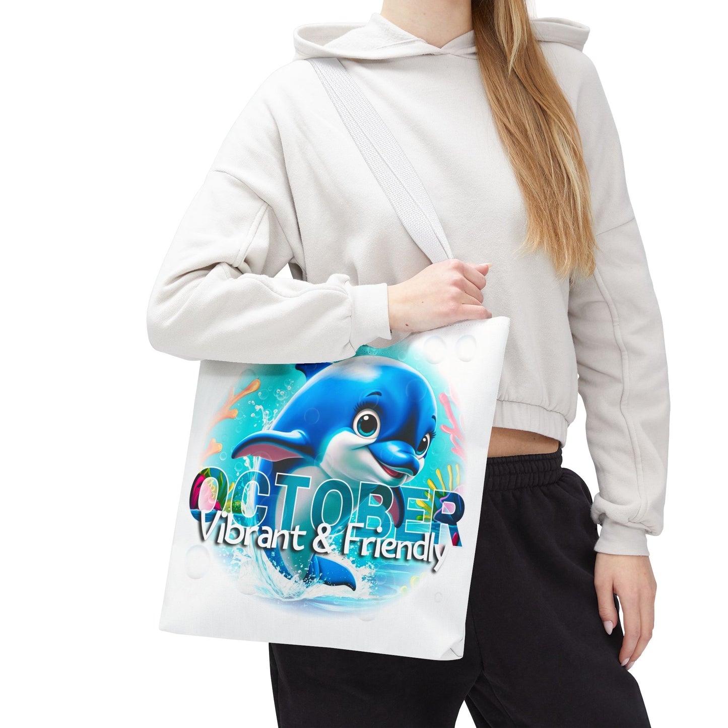 Kids birth month beach tote bag with vibrant October dolphin design carried by person