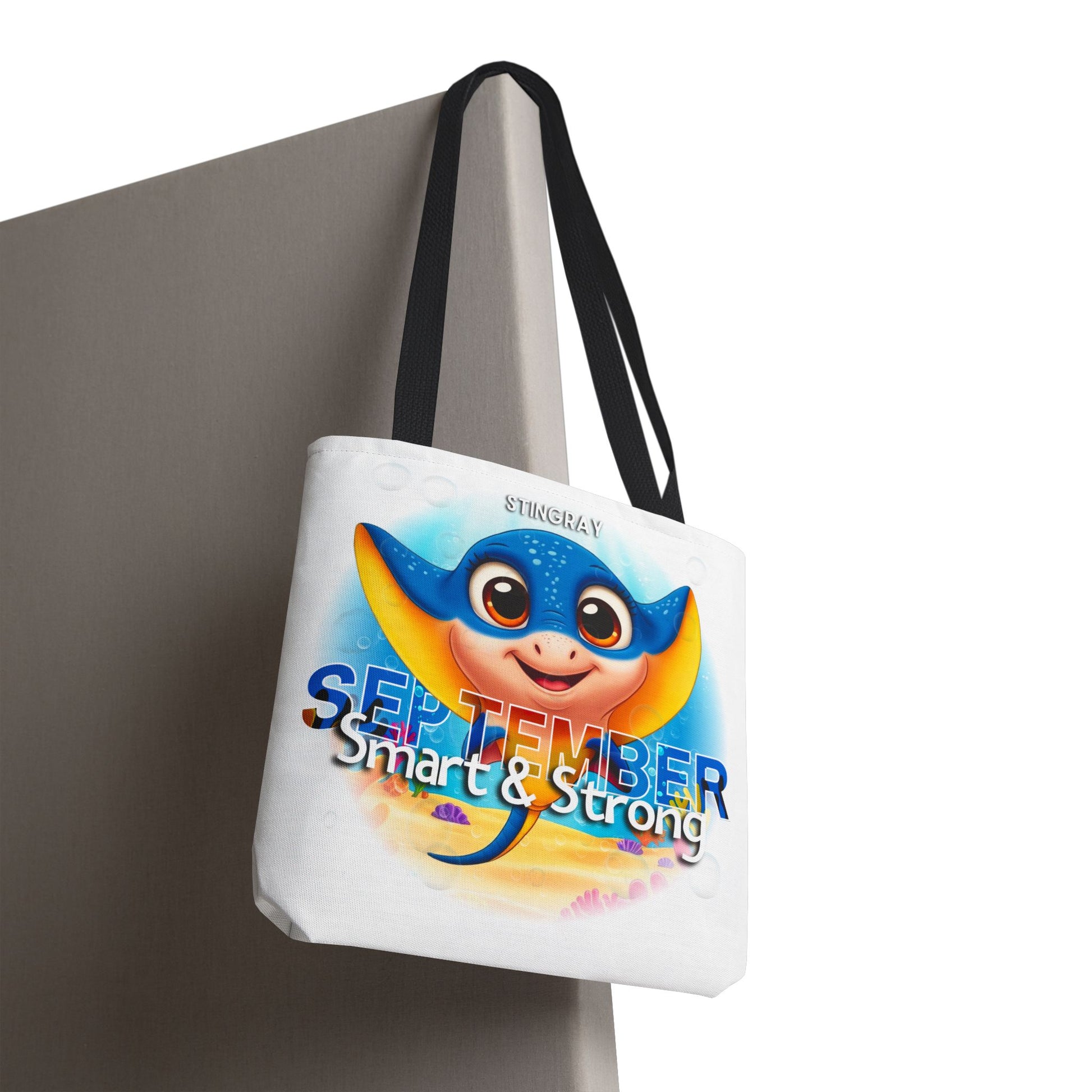 Kids birth month beach tote bag with colorful September stingray design and black handles