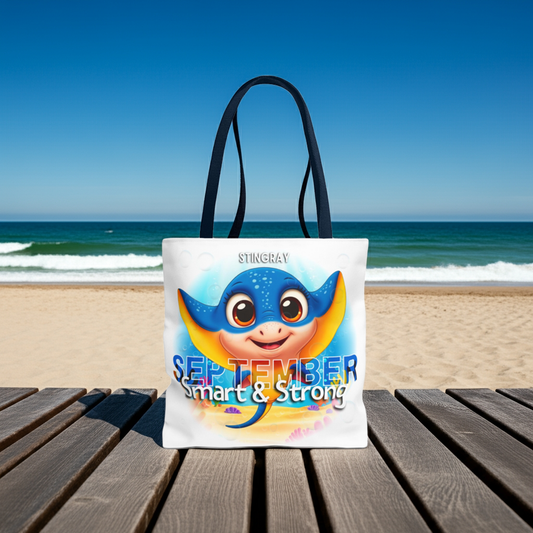 Kids birth month beach tote bag with a cute stingray and September text on the beach