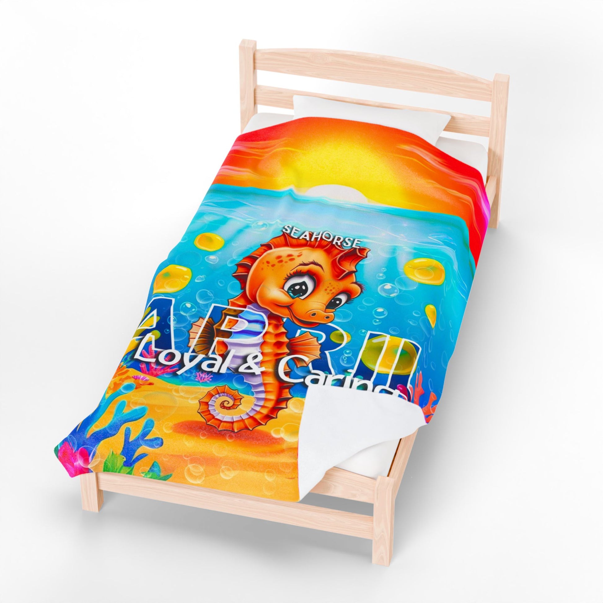 Printify kids birth month blanket with colorful seahorse design and underwater scene on a wooden bed