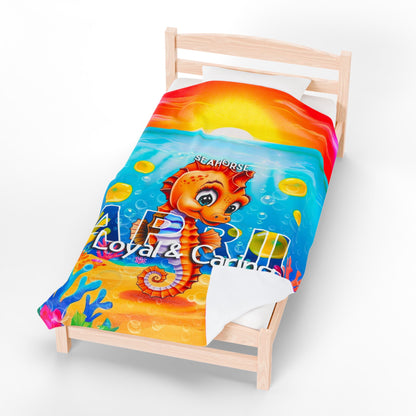 Printify kids birth month blanket with colorful seahorse design and underwater scene on a wooden bed