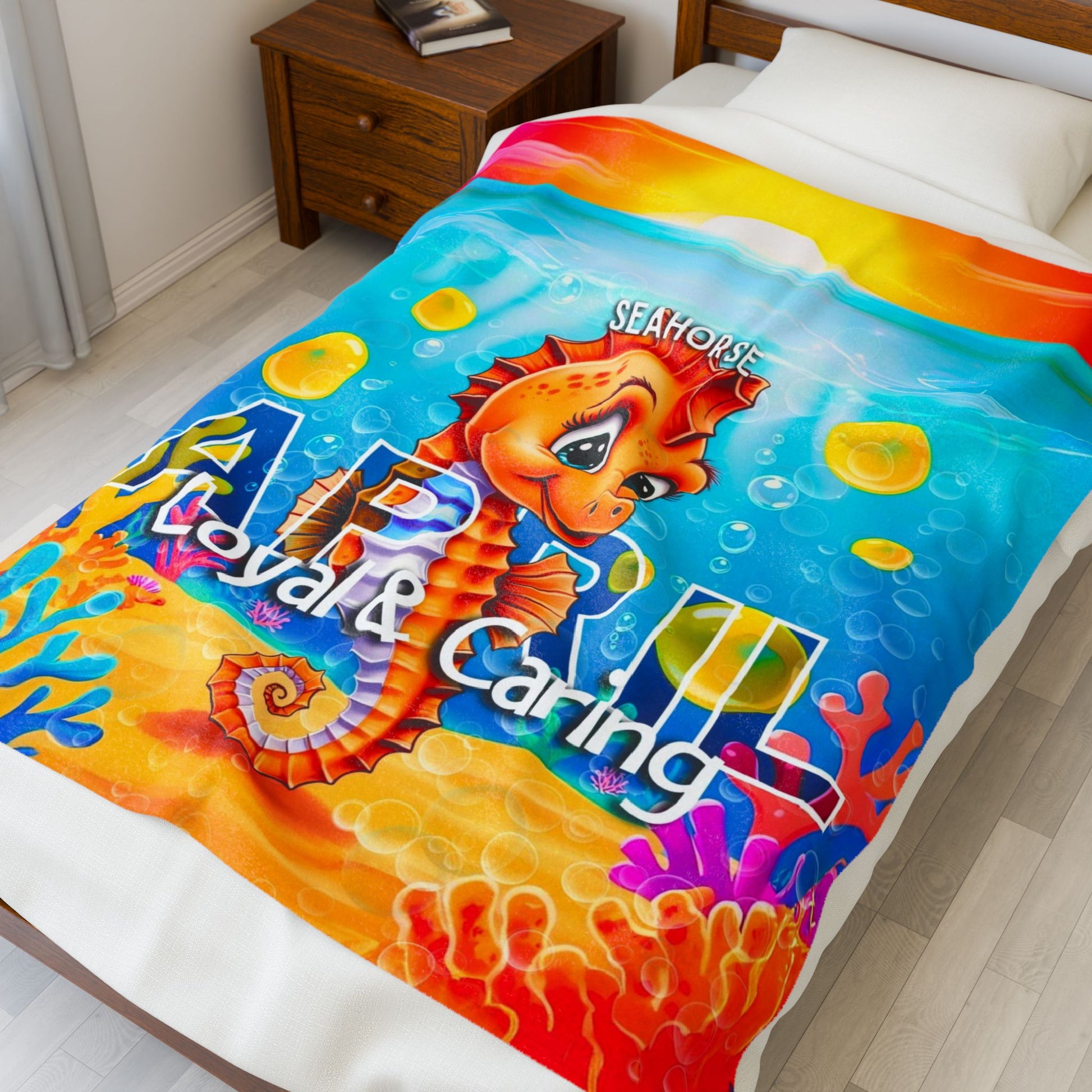 Colorful kids birth month blanket with seahorse design printed by Printify on bed