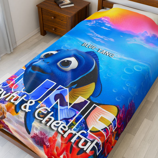 Kids birth month blanket with colorful Blue Tang fish design on bed
