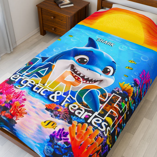 Kids birth month blanket featuring colorful shark and ocean design on a bed 