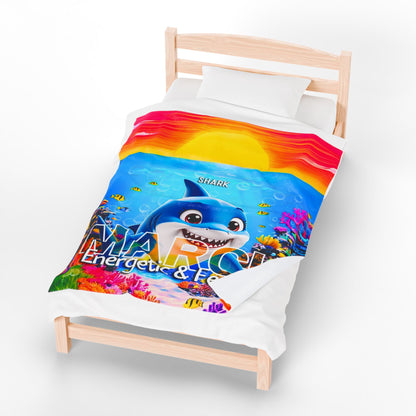 Colorful kids birth month blanket with shark design and vibrant underwater scene on white bed