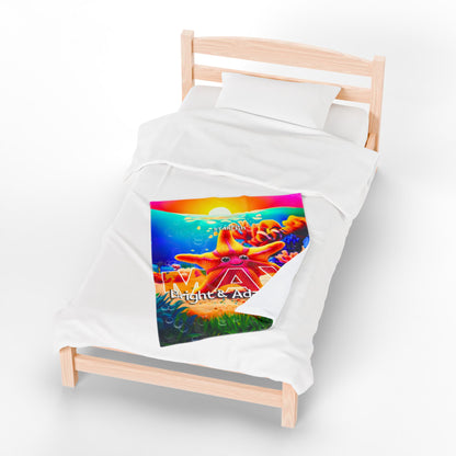 Colorful kids birth month blanket with vibrant starfish design on a white bed with wooden frame
