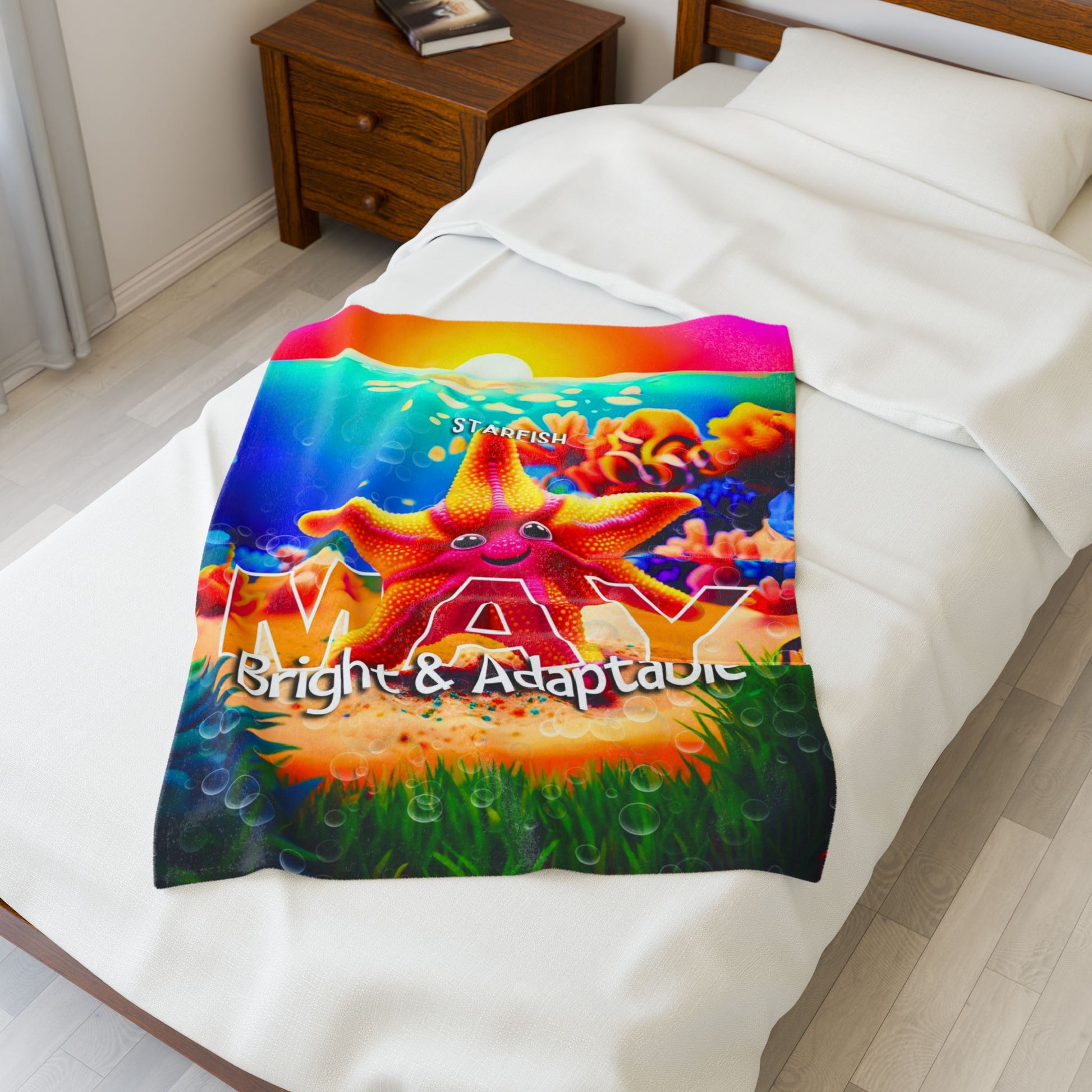 Colorful kids birth month blanket with starfish design and May bright adaptable text on bed