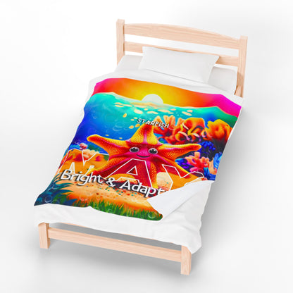 Kids birth month blanket with colorful starfish design and bright underwater theme on single wooden bed