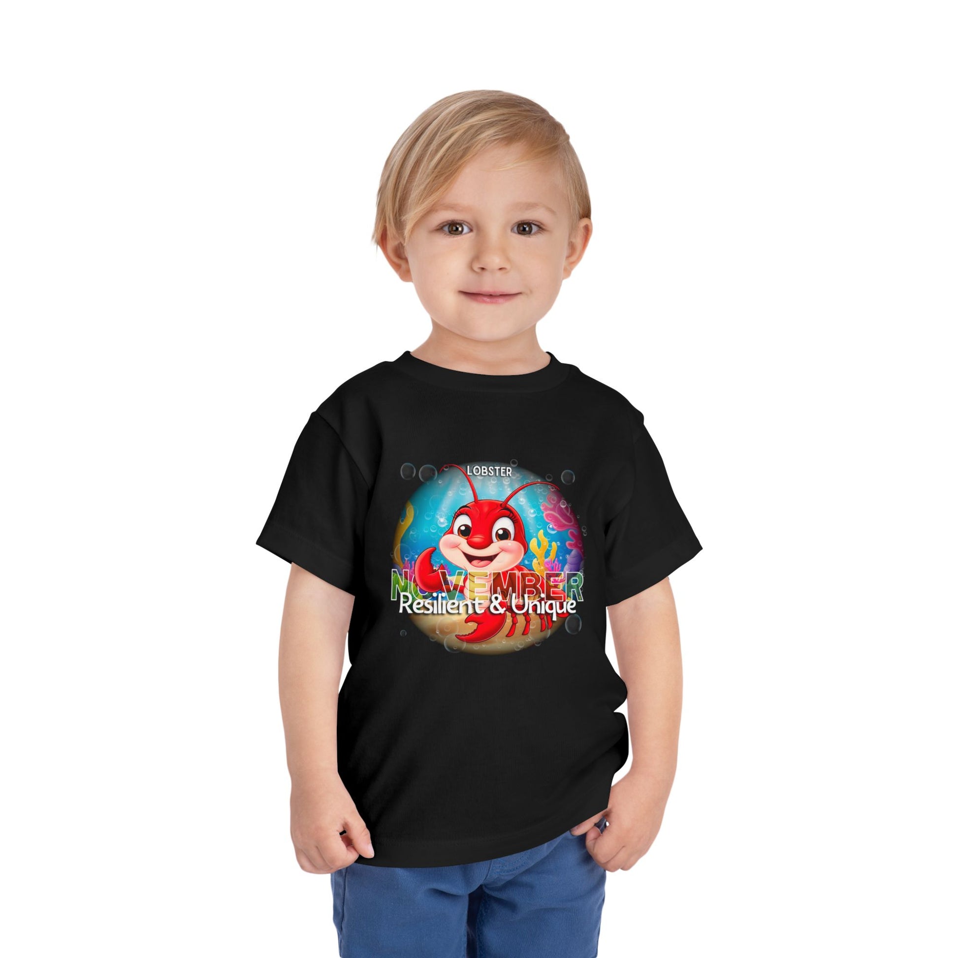 Child wearing a black kids birth month tshirt with November lobster design 