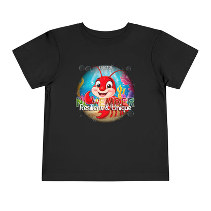 Black kids birth month tshirt featuring a colorful lobster and November text with Resilient and Unique slogan