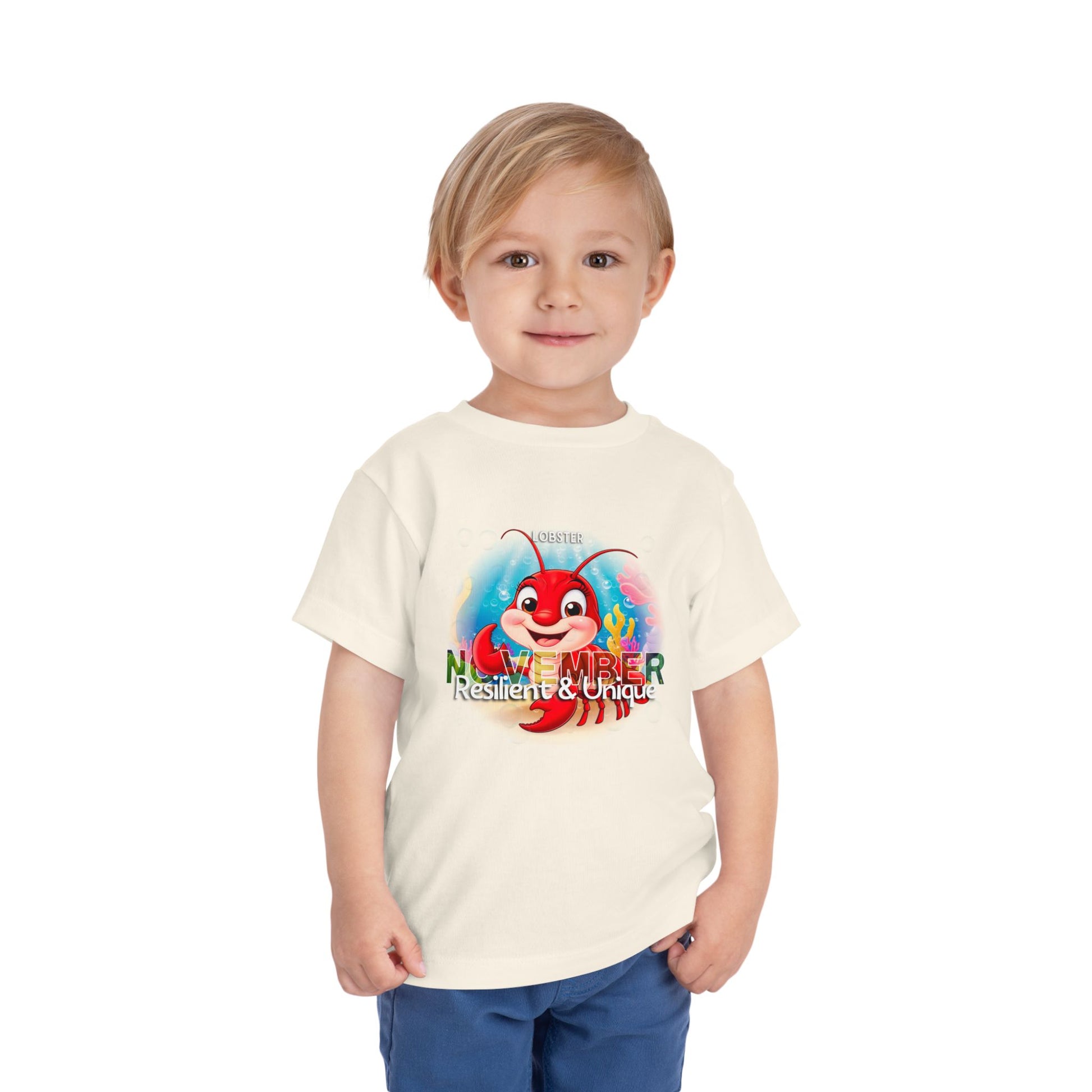 Boy wearing kids birth month tshirt with November crab design in white short sleeve