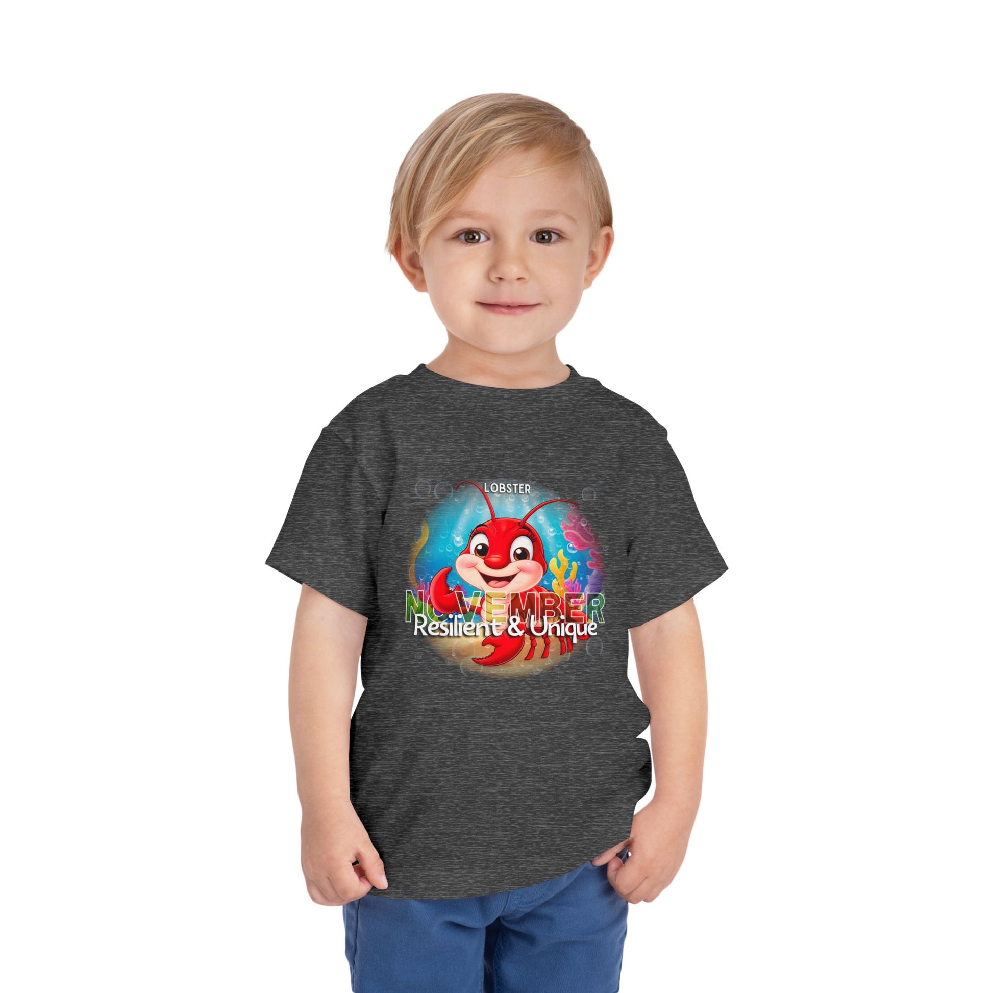 Child wearing a kids birth month tshirt featuring a colorful lobster design for November 