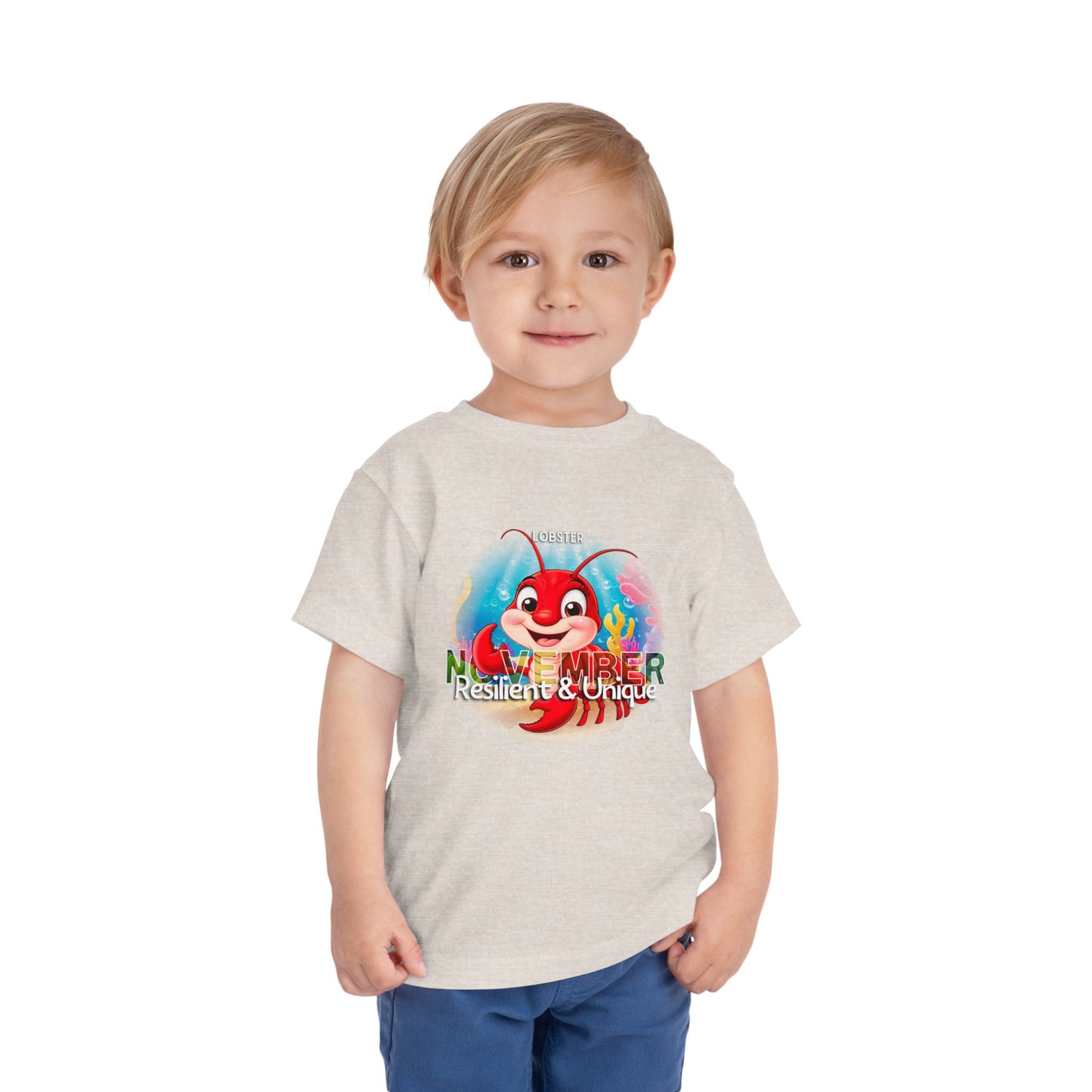 Toddler wearing a kids birth month tshirt with a colorful November lobster design
