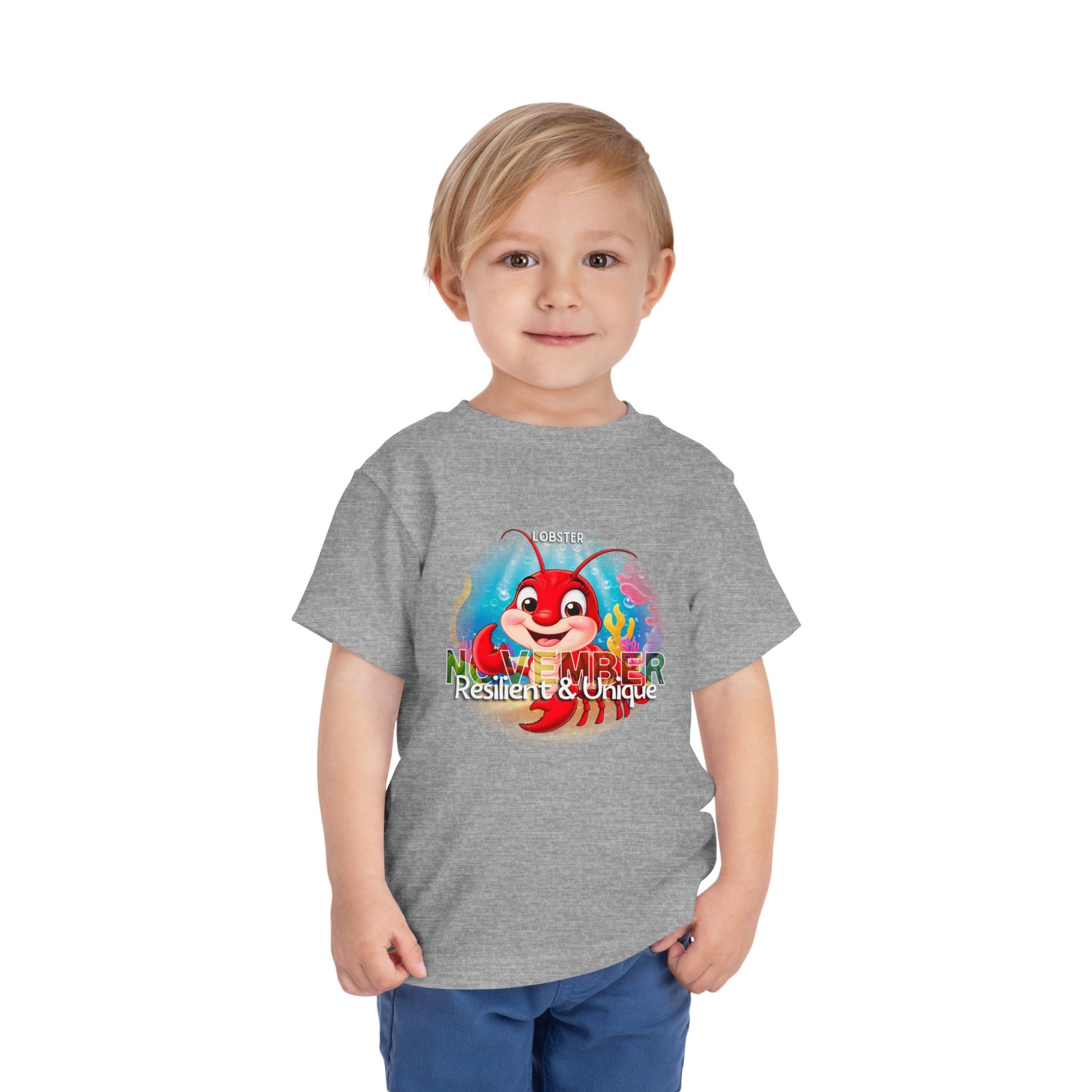 Toddler wearing kids birth month tshirt with November lobster design in gray