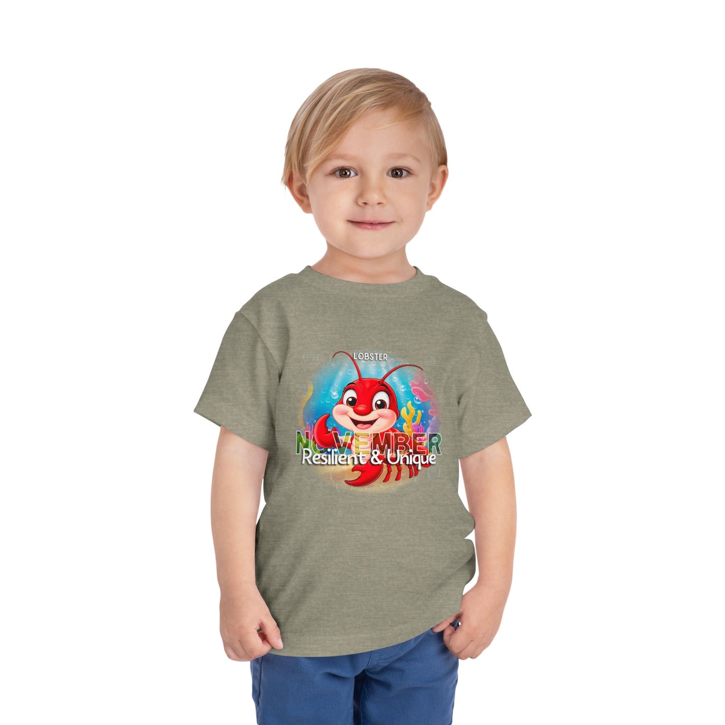 Toddler wearing kids birth month tshirt with November lobster design and Resilient Unique text