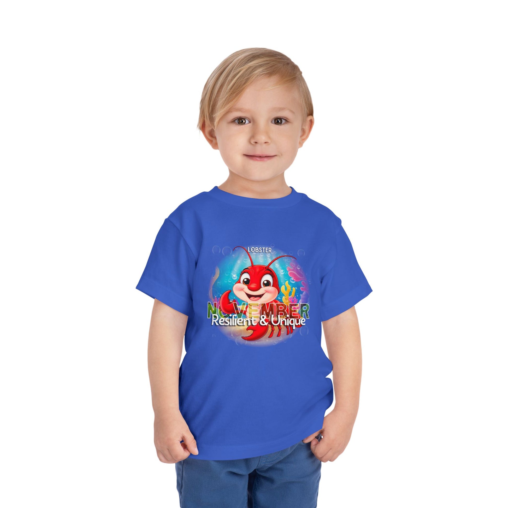 Child wearing a blue kids birth month tshirt featuring a November lobster design 