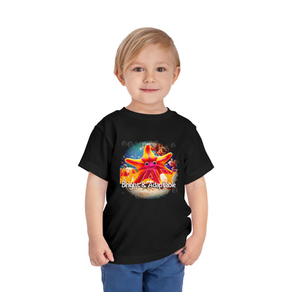 Toddler wearing a black kids birth month tshirt with a colorful starfish design and text bright and adaptable