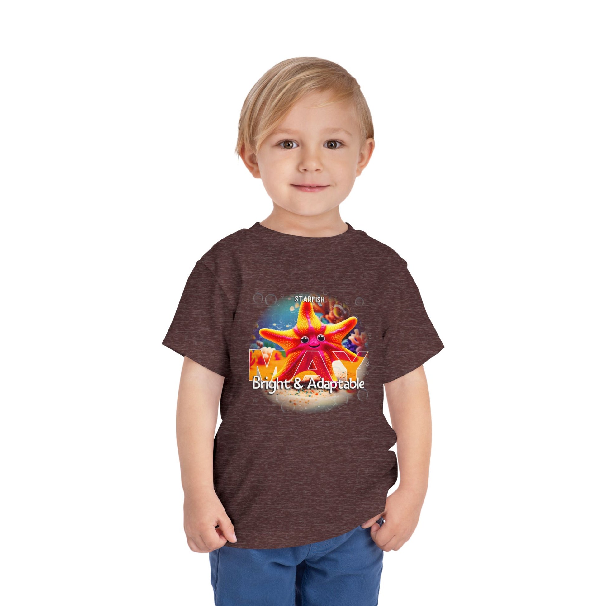 Child wearing a kids birth month tshirt with colorful starfish design and bright adaptable text