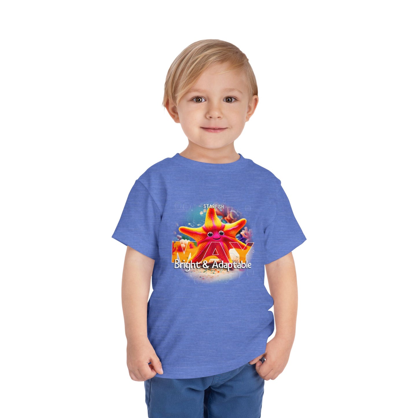 Kids birth month tshirt in blue with May starfish design worn by smiling young boy