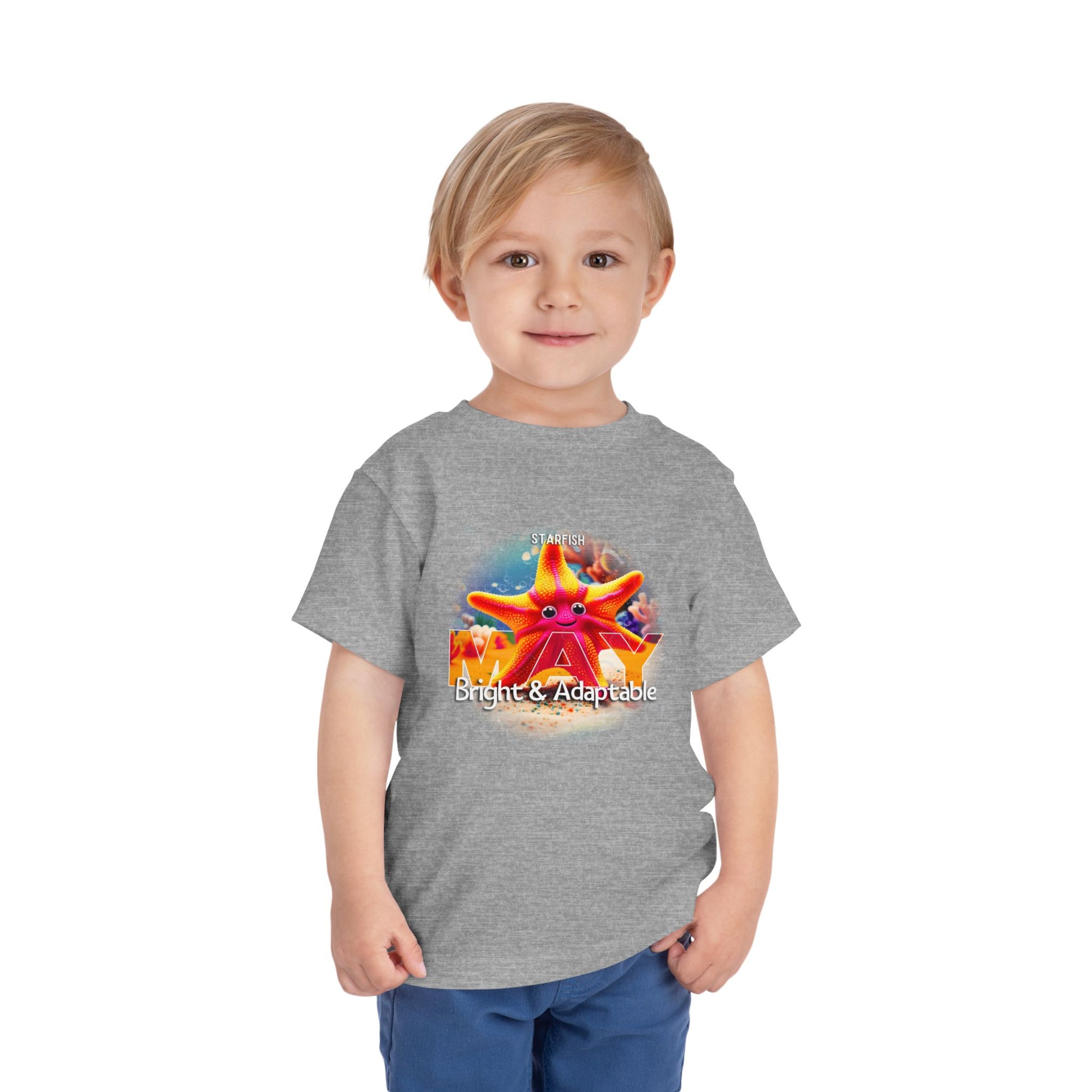 Toddler boy wearing a gray kids birth month tshirt with colorful May starfish design