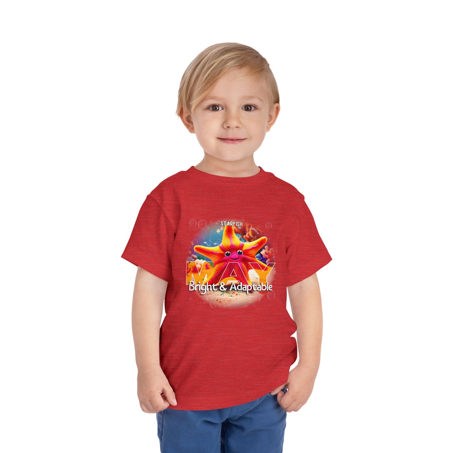 Toddler wearing a red kids birth month tshirt featuring a colorful starfish design with bright and adaptable text
