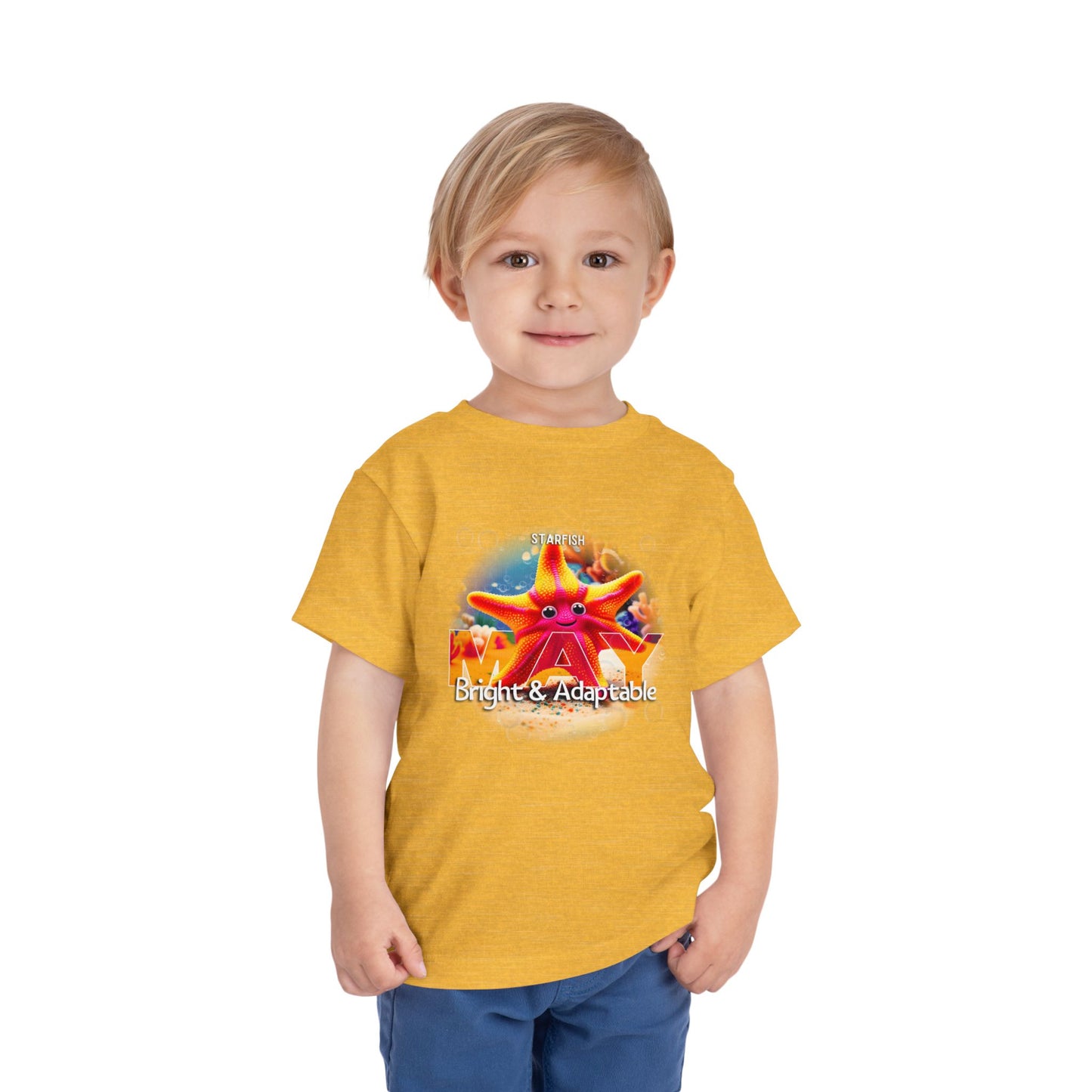 Toddler wearing a yellow kids birth month tshirt with colorful starfish design and text bright and adaptable