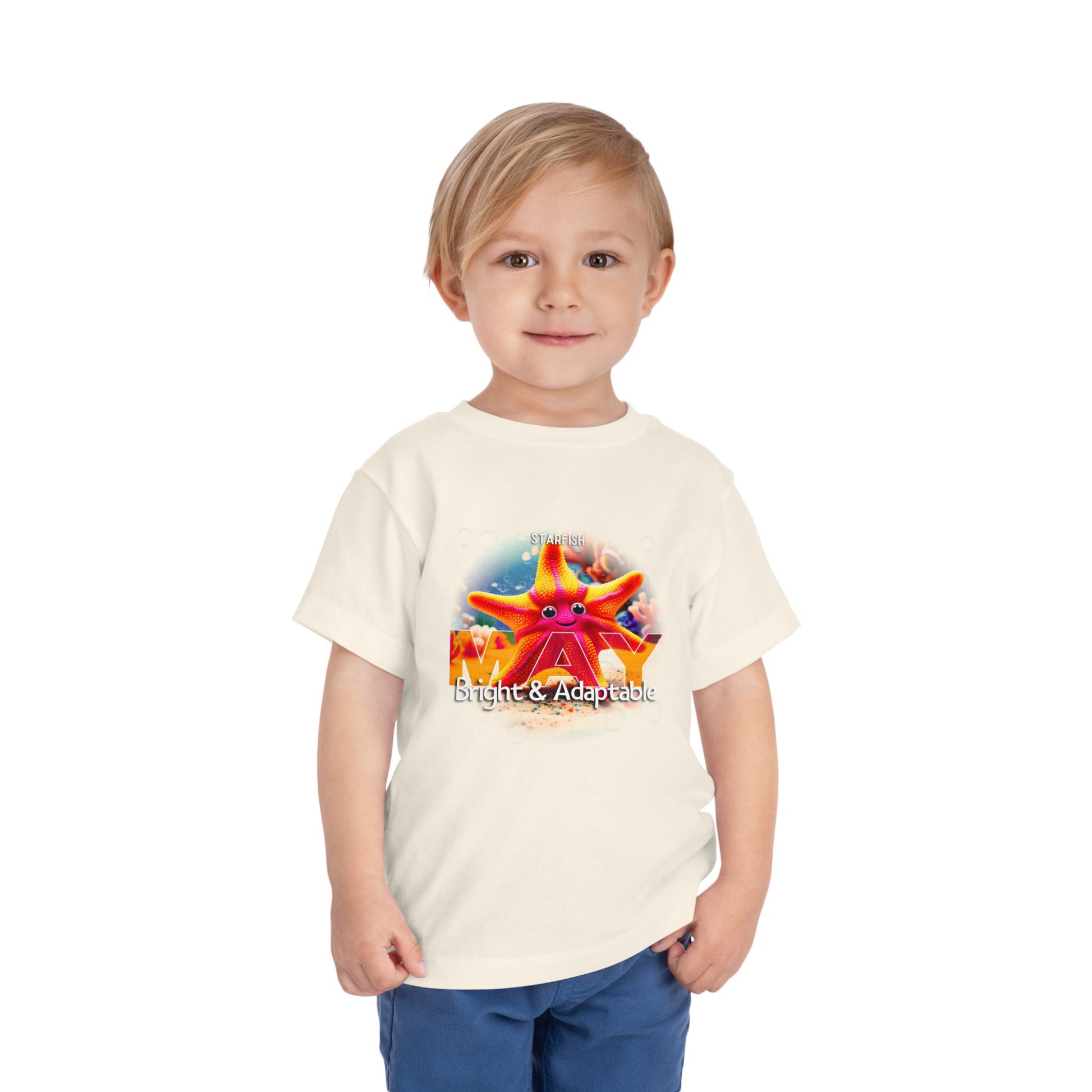 Toddler wearing a kids birth month tshirt with a bright starfish design and adaptable theme