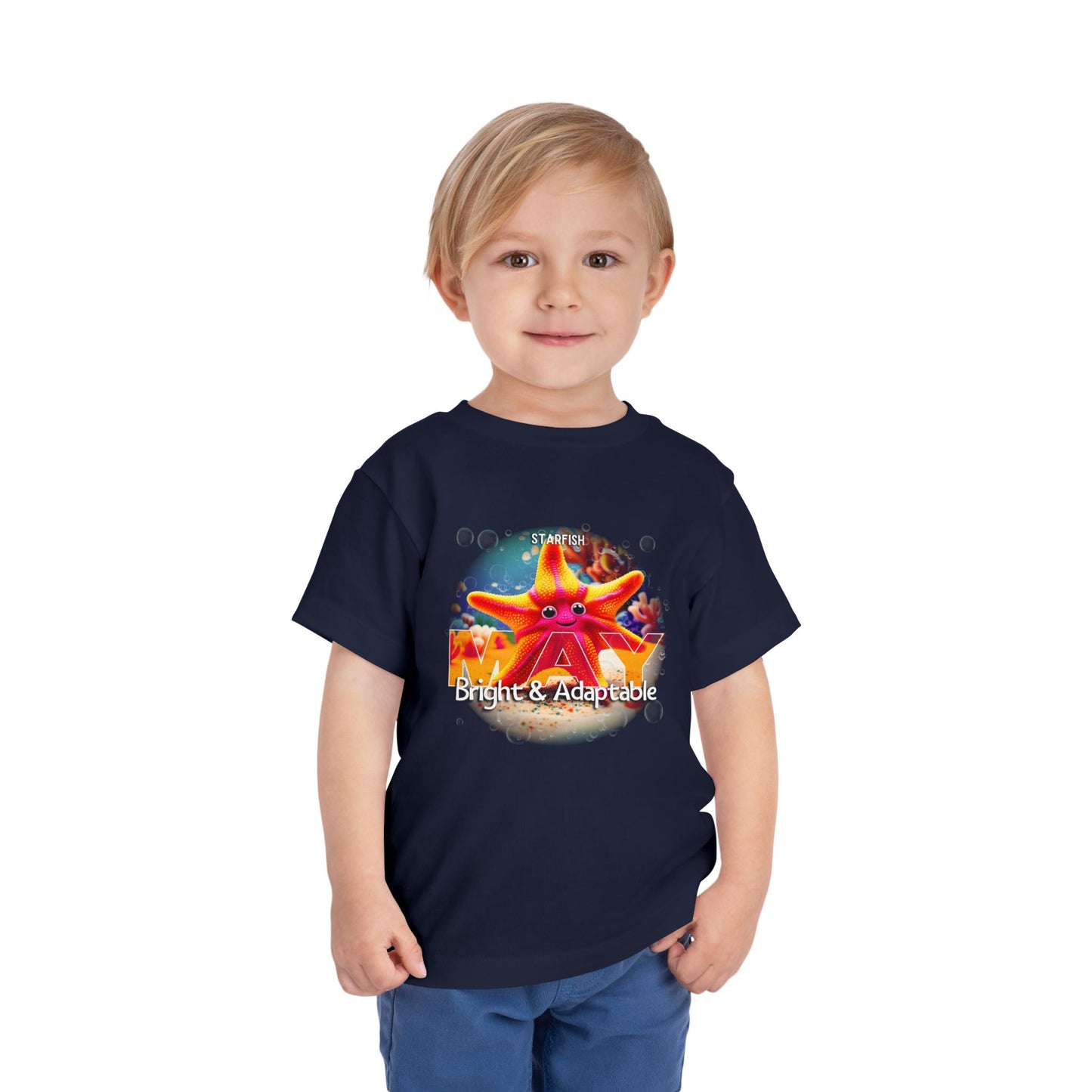 Young boy wearing a navy kids birth month tshirt with colorful starfish design for May