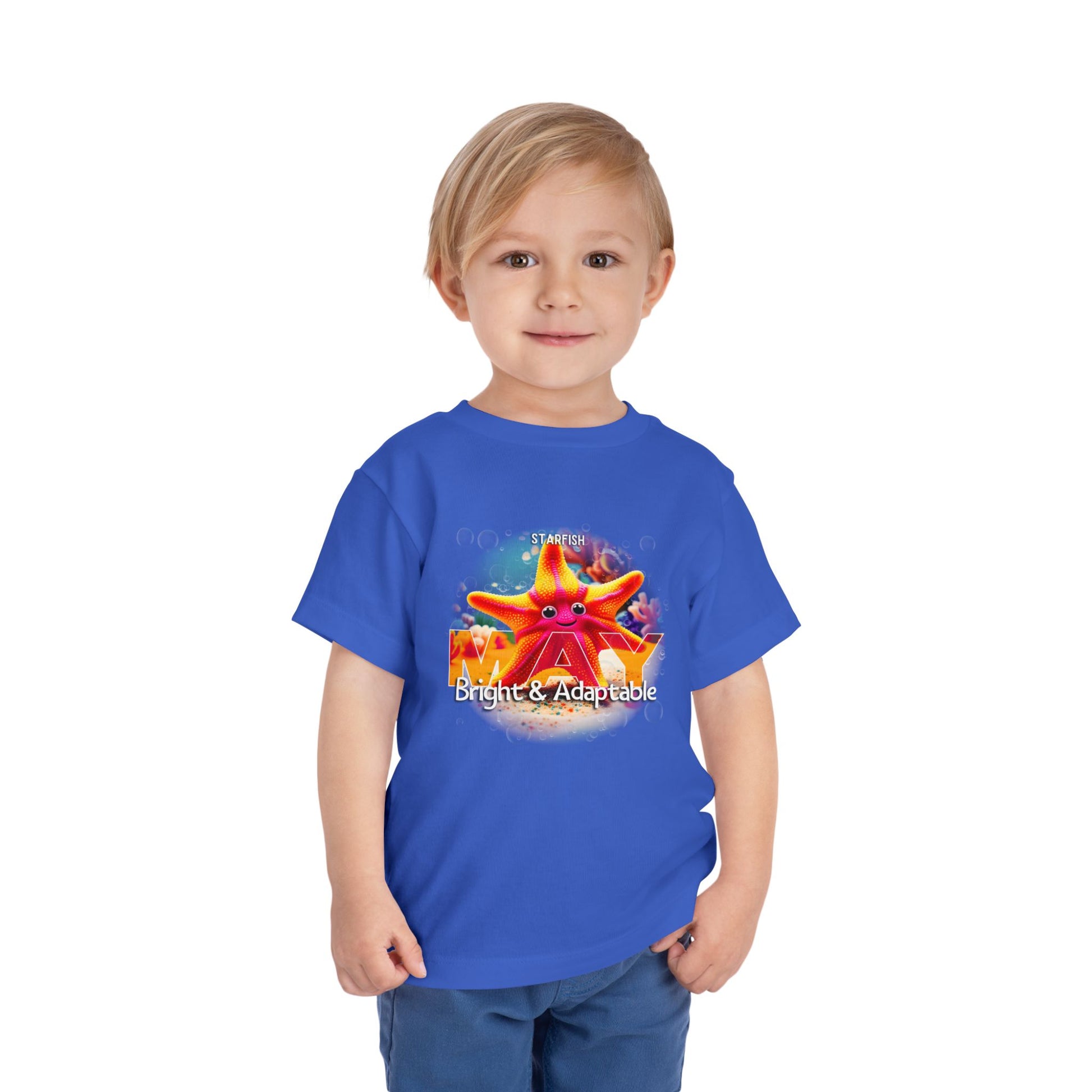 Toddler wearing a blue kids birth month tshirt featuring a colorful starfish design with the word May