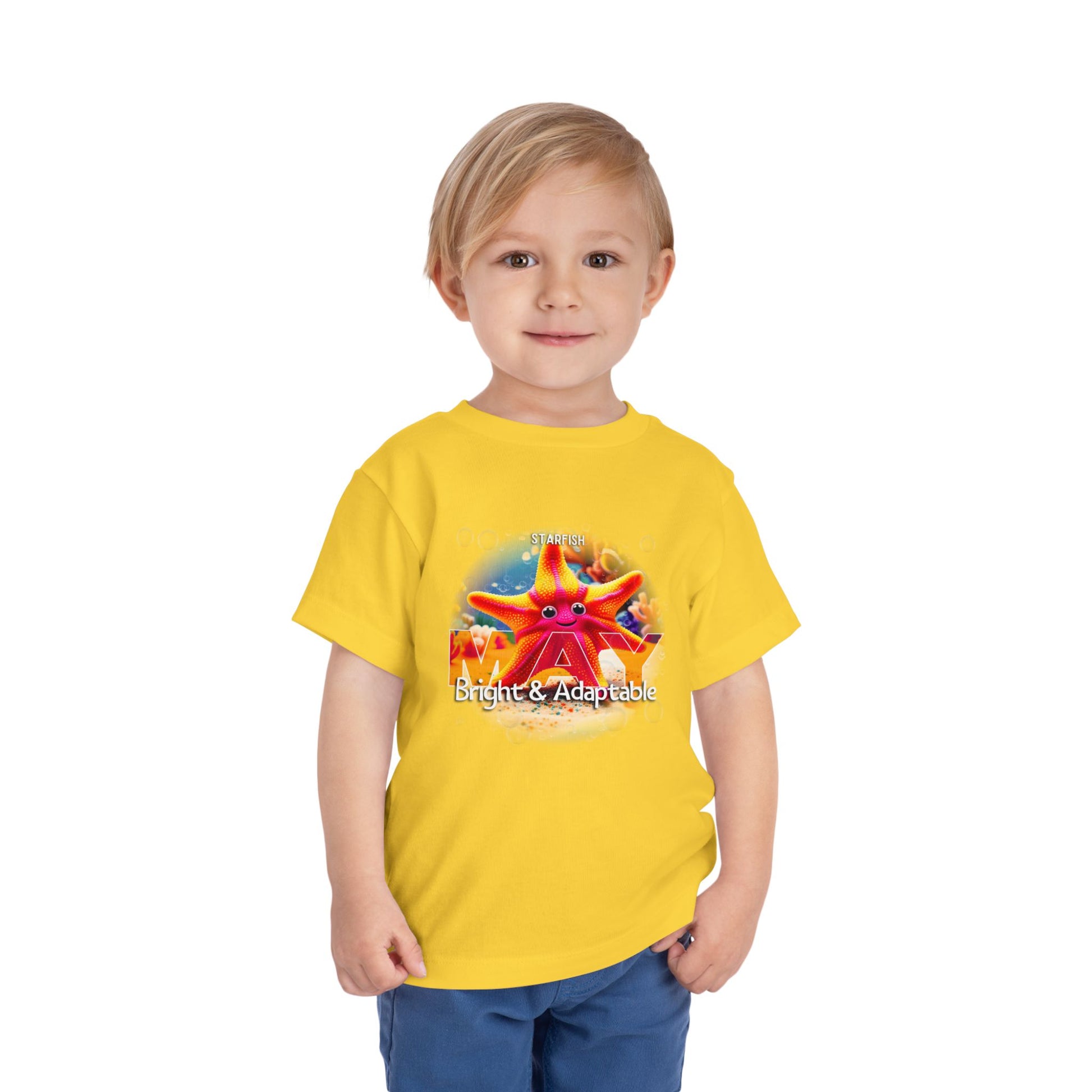 Toddler wearing yellow kids birth month tshirt with bright and adaptable starfish design