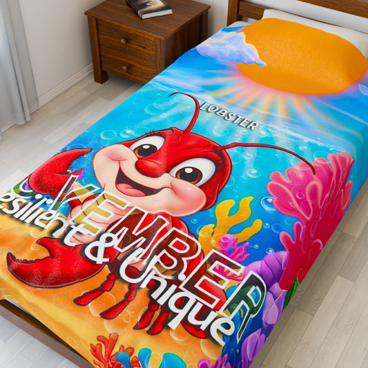Kids birth month blanket featuring colorful lobster design printed on a twin bed